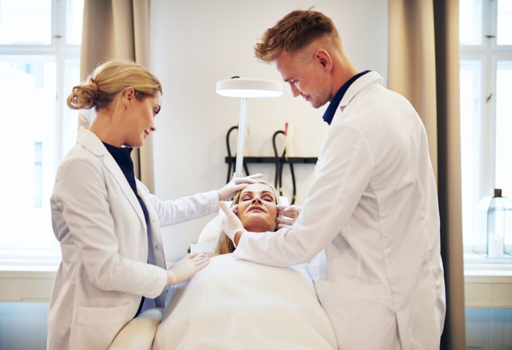 doctors-discussing-cosmetic-surgery-options-over-a-client-jpg-2